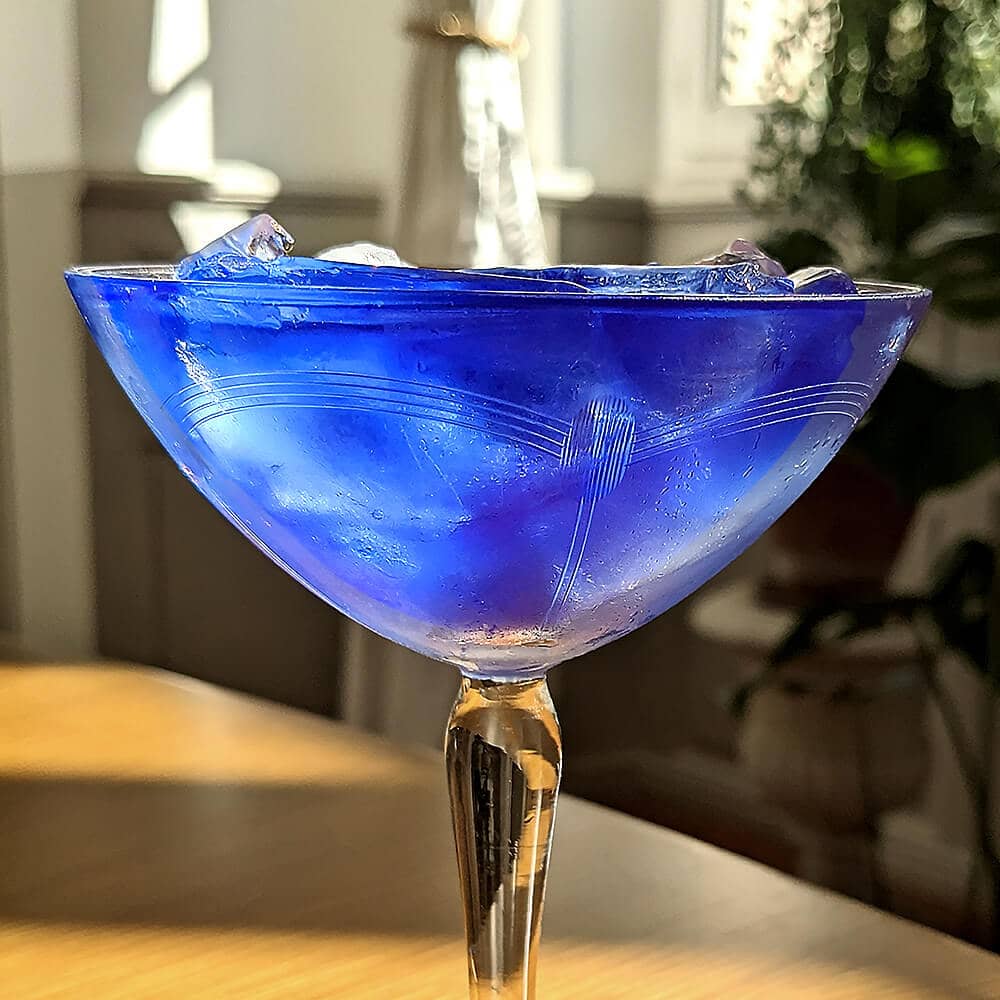 blue martini made with Corsican gin, cucumber, and butterfly pea tea